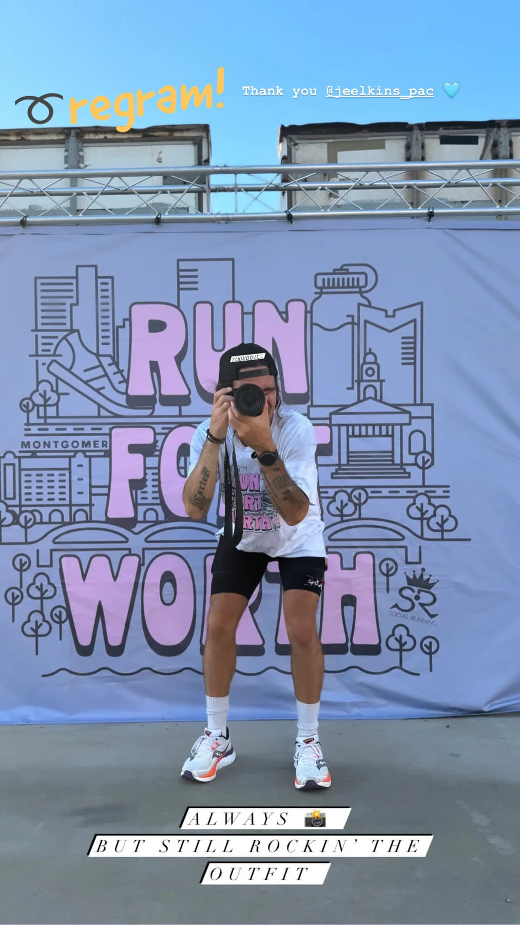 Gregory holding a camera at a running event