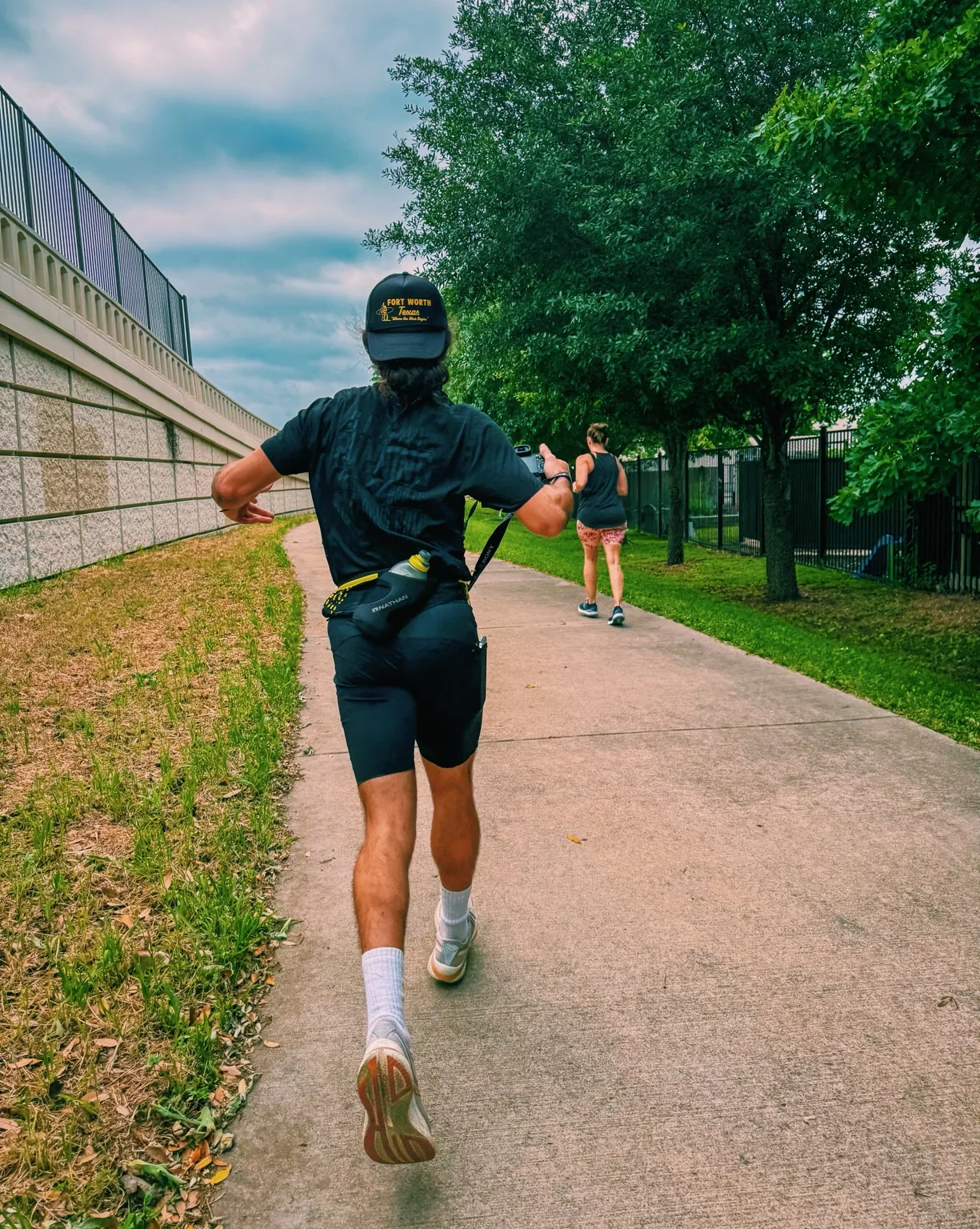 Gregory photographing runners outdoors