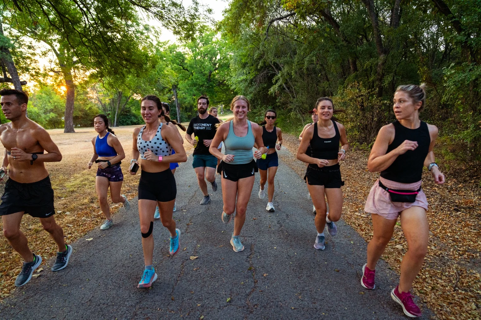 Group of runners on a tree-lined trail