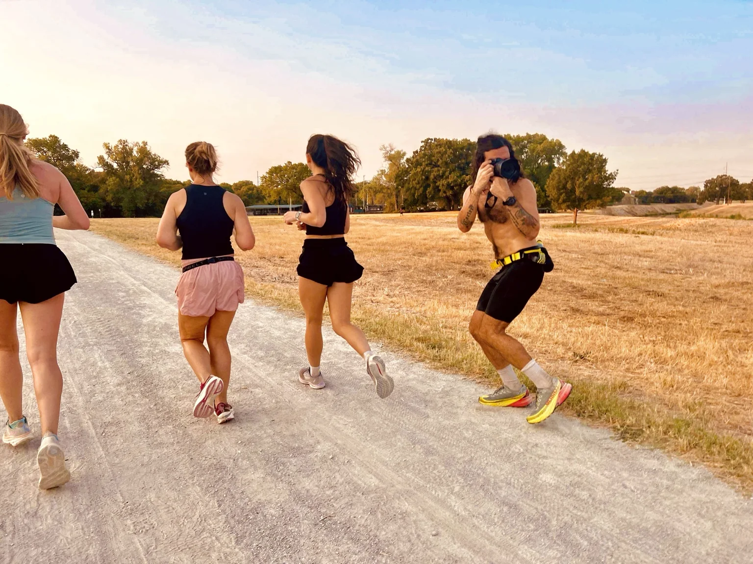 Gregory photographing runners while moving alongside them